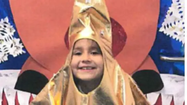 Sara smiling wearing a gold star costume