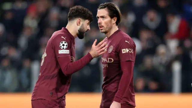 Josko Gvardiol of Manchester City interacts with teammate Jack Grealish