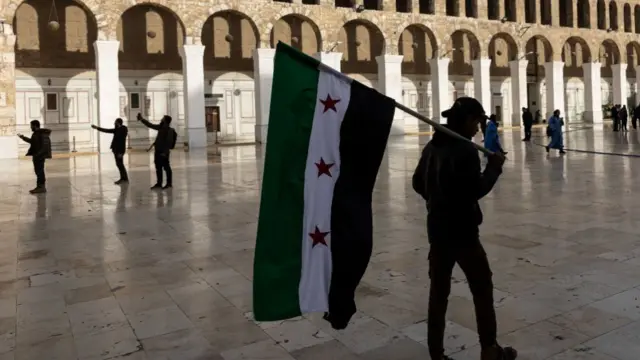 visitors gather at the nearby Umayyad Mosque, a symbol of the city's rich cultural and religious heritage as life is gradually returning to normal in Damascus after the city fell into the hands of opposition forces on December 10, 2024 in Damascus, Syria