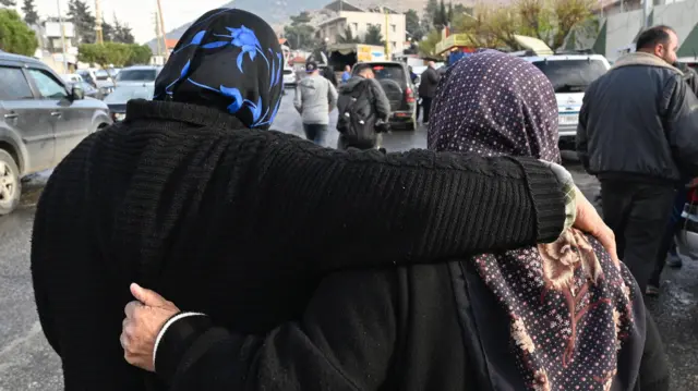 Women embrace as they wait at the Al-Masnaa crossing to return to Syria, on the Lebanese-Syrian border, Lebanon, 11 December 2024