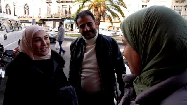 A man and a woman stop to talk to the BBC's Sally Nabil in Damascus