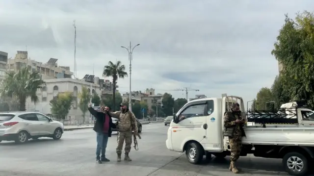 Hammam and his cousin take a photo together in the middle of the road