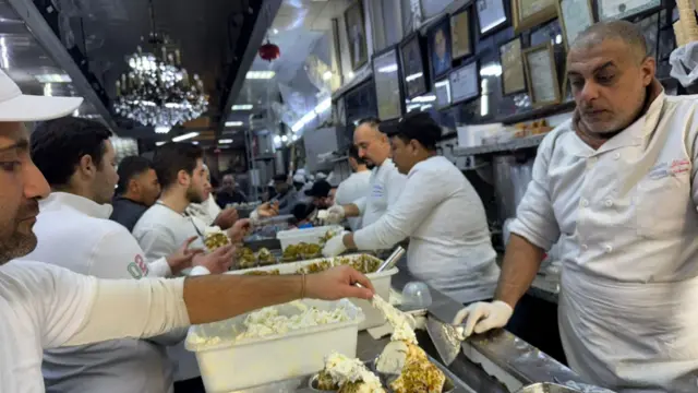 A man scoops ice-cream at the famous Bakdash parlour in Damascus