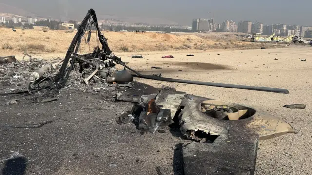 Military vehicles and helicopters inside Mezzeh Air Base are damaged as a result of the Israeli attack on the Air Base in the capital Damascus, Syria