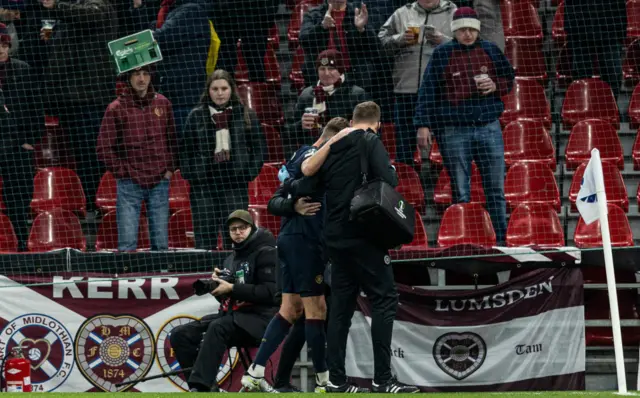 Frankie Kent has to be helped off the pitch after getting injured in the first half.