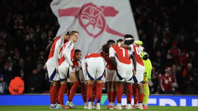 Arsenal players huddle before game against Monaco