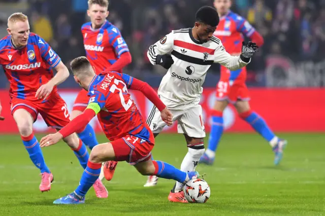 Viktoria Plzen midfielder Lukas Kalvach and Manchester United midfielder Amad Diallo vie for the ball