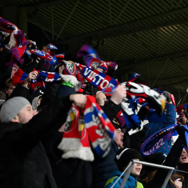 Home fans waves scarves in celebration