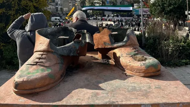 A pair of rusty shoes is all that's left of a statue for Hafeez al-Assad