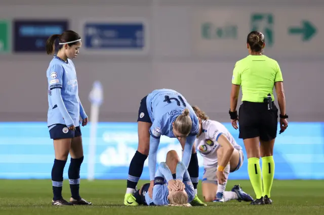 Alex Greenwood is consoled after getting injury