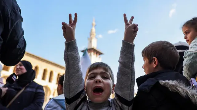 A person gestures before the first Friday prayers at the Umayyad Mosque, after fighters of the ruling Syrian body ousted Syria's Bashar al-Assad, in the Damascus old city, Syria,