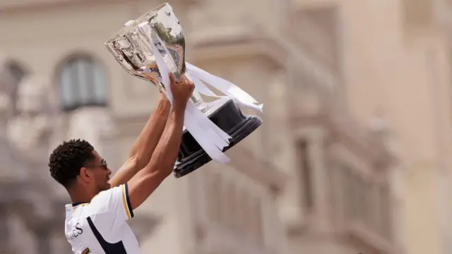 Jude Bellingham lifts the La Liga trophy during celebrations in Madrid