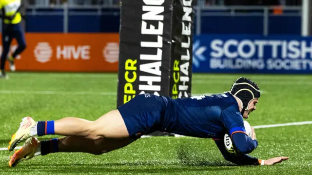 Darcy Graham dives under the posts to score Edinburgh's third try