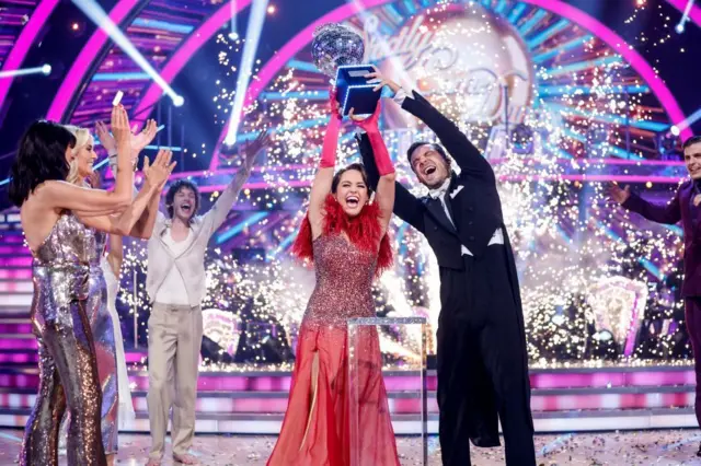 Coronation Street actress Ellie Leach lifts the glitterball trophy with her professional partner Vito Coppola