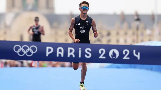 Alex Yee sprints towards the triathlon finish line with Hayden Wilde in the background