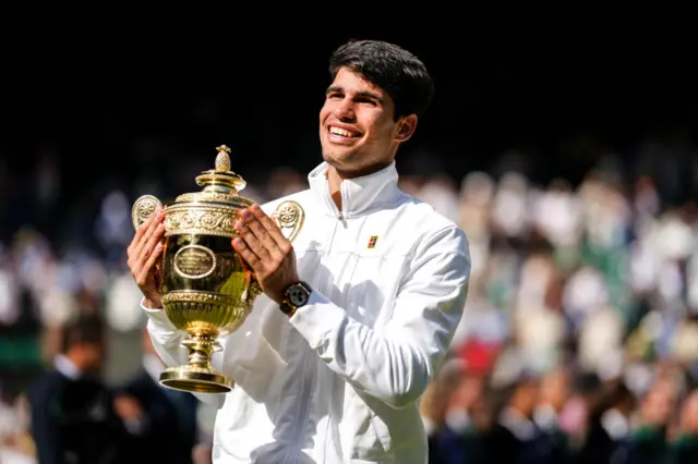 Carlos Alcaraz with Wimbledon trophy