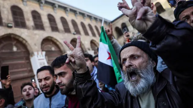 A person gestures before the first Friday prayers at the Umayyad Mosque, after fighters of the ruling Syrian body ousted Syria's Bashar al-Assad, in the Damascus old city, Syria,