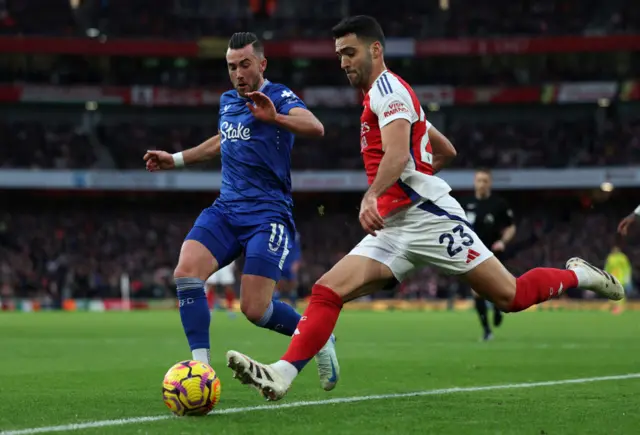 Arsenal midfielder Mikel Merino crosses past Jack Harrison