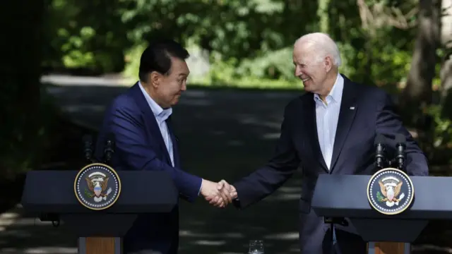 US President Joe Biden, right, and Yoon Suk Yeol, South Korea's president, shales hands at a news conference