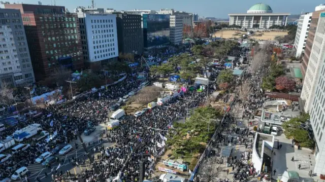 Protesters gathering during a rally calling for the impeachment of South Korean President Yoon Suk Yeol outside the National Assembly in Seoul