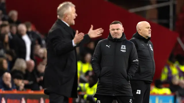 Wayne Rooney and Chris Wilder (left) on the touchline