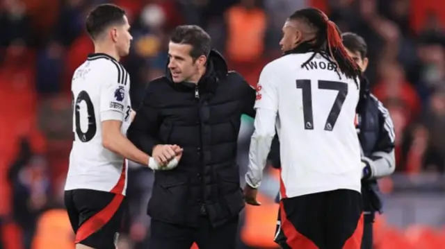 Fulham manager Marco Silva embraces Sasa Lukic of Fulham (C) and Alex Iwobi