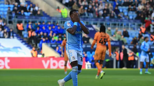 A Coventry player with his hands over his face