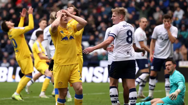 Dan James holds his head in his hands