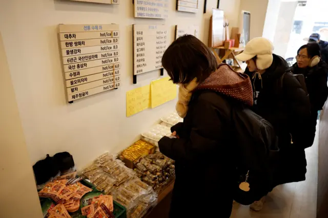 Protesters take free drinks and snacks in a cafe