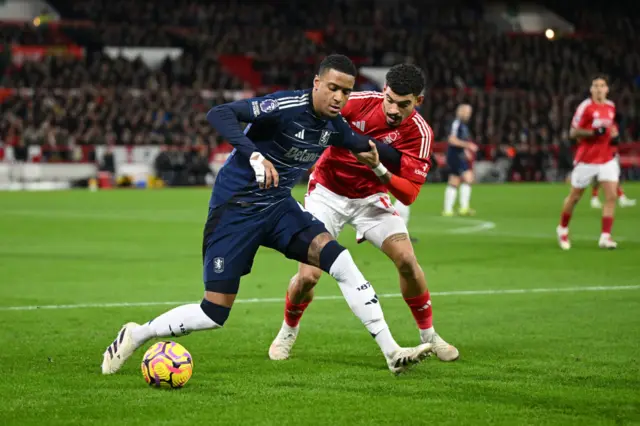 Ezri Konsa of Aston Villa is challenged by Morgan Gibbs-White of Nottingham Forest