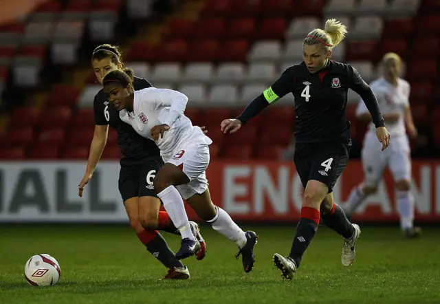 LINCOLN, ENGLAND - APRIL 02: Nikita Parris of England challenges for the ball with Angharad James and Lauren Price of Wales during the UEFA European Women's U19 Championship Qualifier match between England and Wales at Sincil Bank Stadium on April 2, 2012 in Lincoln, England. (Photo by Matt Lewis - The FA/The FA via Getty Images)