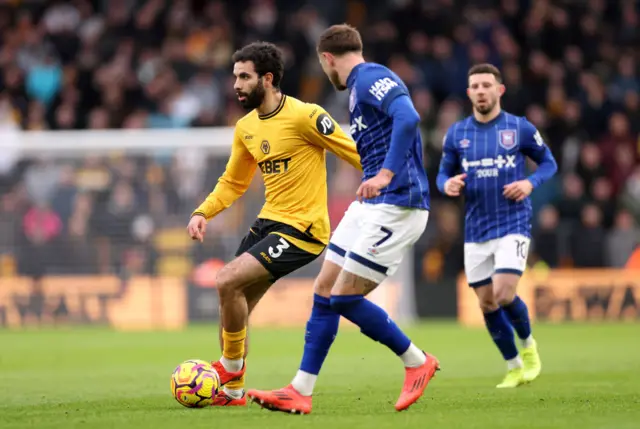 : Rayan Ait-Nouri of Wolverhampton Wanderers runs with the ball from Wes Burns of Ipswich Town