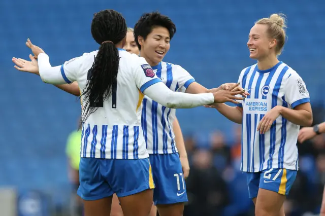 Brighton players congratulate Seike for a goal