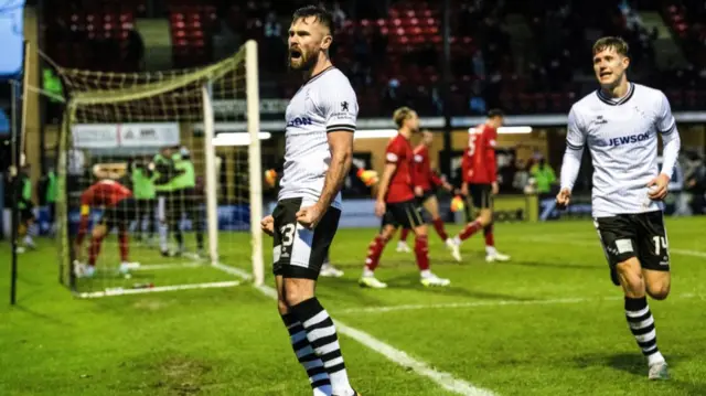 Scott McMann celebrates after scoring for Ayr United against Falkirk