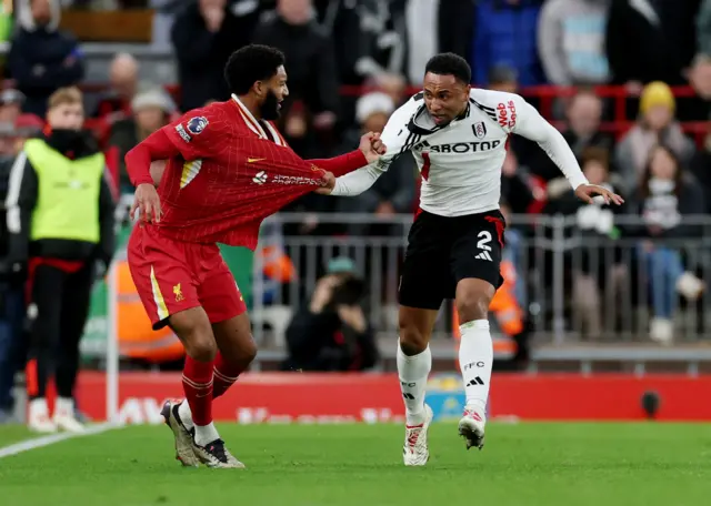 Fulham's Kenny Tete clashes with Liverpool's Joe Gomez