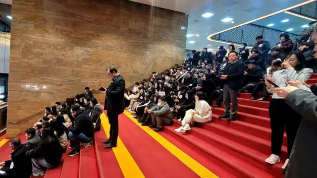 Members of the main opposition Democratic Party have gathered on the steps of the rotunda