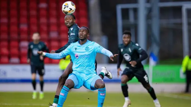 St Mirren's Elvis Bwomono holds off St Johnstone's Benjamin Kimpioka