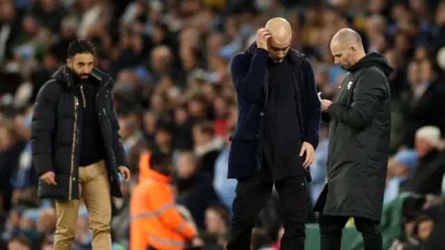 Pep Guardiola, Manager of Manchester City, looks dejected