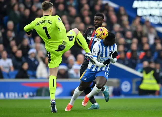 Crystal Palace's Dean Henderson in action with Brighton & Hove Albion's Yankuba Minteh