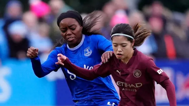 Toni Payne (left) and Manchester City's Yui Hasegawa battle for the ball