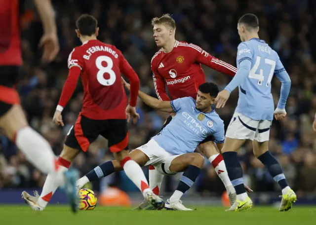 Manchester City's Matheus Nunes in action with Manchester United's Rasmus Hojlund