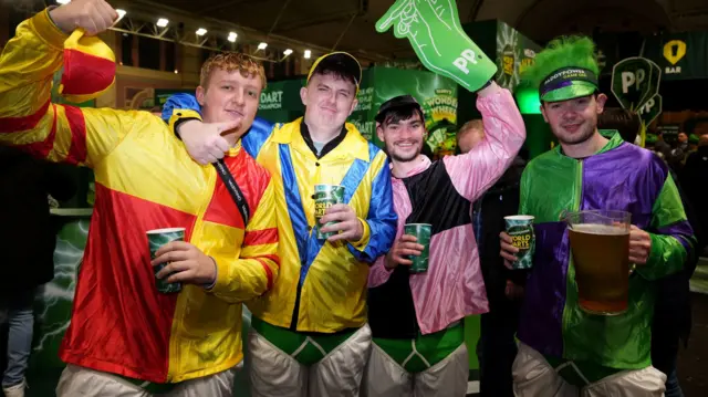 Fans with drinks at the darts