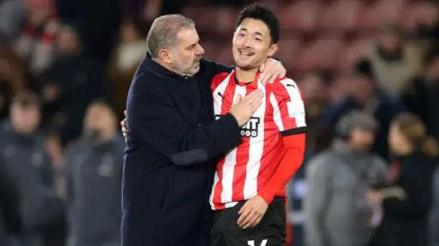 Ange Postecoglou, Manager of Tottenham Hotspur, interacts with Yukinari Sugawara of Southampton