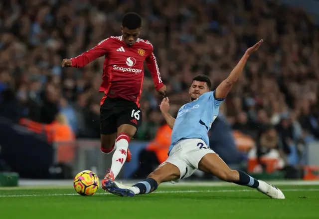 Manchester United's Amad Diallo in action with Manchester City's Matheus Nunes