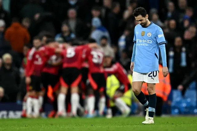 Bernardo Silva reacts as Manchester United's Ivorian midfielder Amad Diallo celebrates scoring