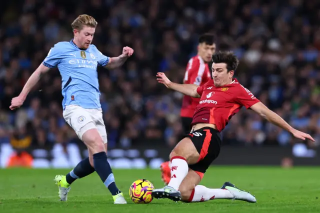 Kevin De Bruyne of Manchester City and Harry Maguire of Manchester United