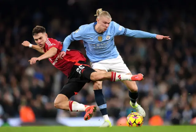 Manuel Ugarte of Manchester United and Erling Haaland of Manchester City battle for possession