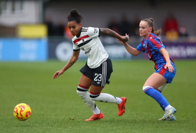 Geyse Da Silva Ferreira of Manchester United runs with the ball whilst under pressure from Lily Woodham