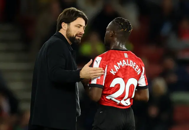 Southampton's Kamaldeen Sulemana with Southampton manager Russell Martin after being substituted