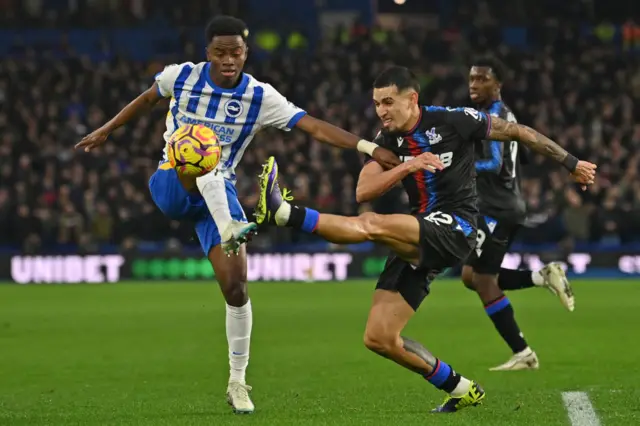 Simon Adingra vies with Crystal Palace defender Daniel Munoz